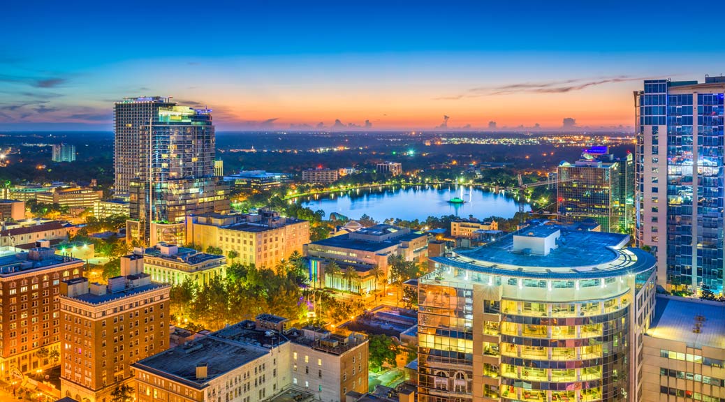 Orlando, Florida, USA aerial cityscape towards Lake Eola at dusk.