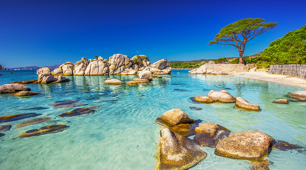 Clear amazing azure coloured sea water with gtanote rocks in Capriccioli beach, Sardinia, Italy