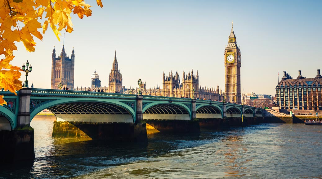 Big Ben and Houses of parliament against autumn leaves in London UK