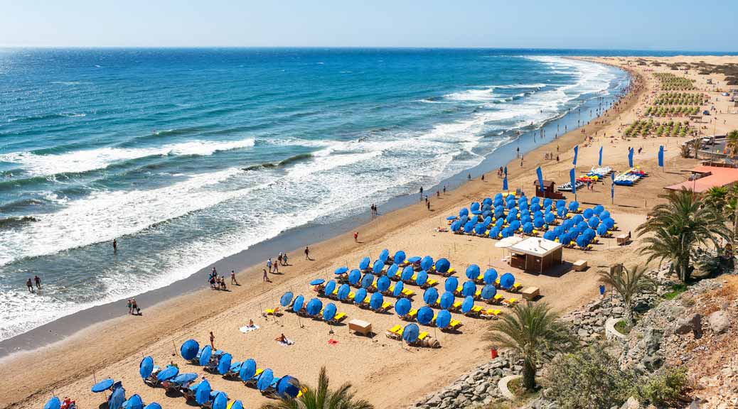 tourists enjoying in a sunny day in a beautiful beach Playa del Ingles Maspalomas Gran Canaria