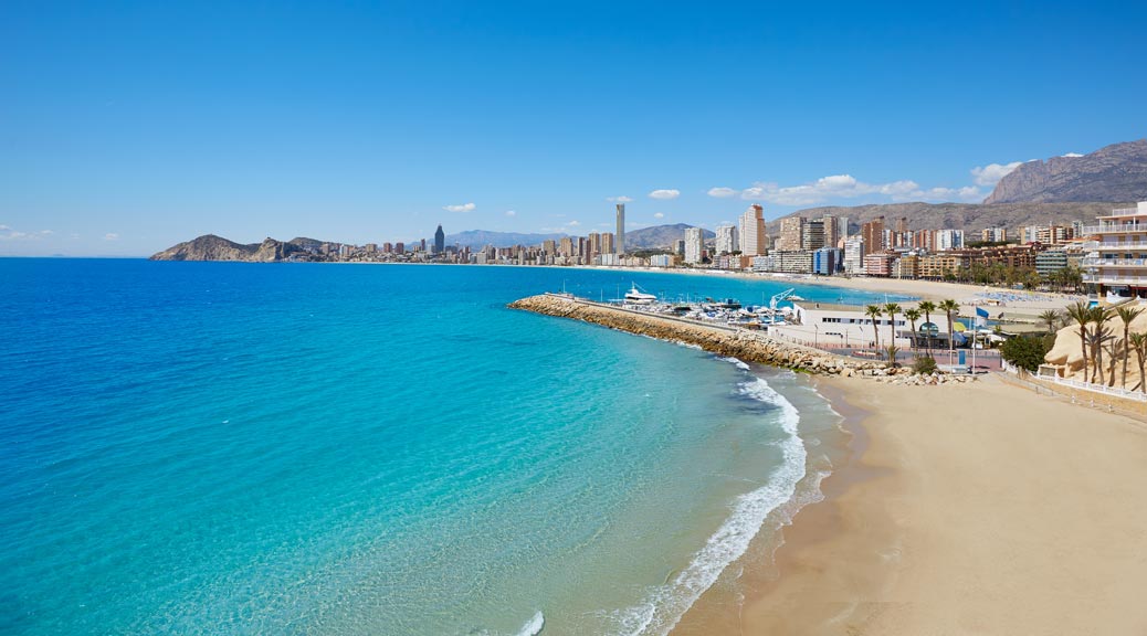 stunning looking blue water and white sandy beach in benidorm spain