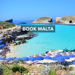 Blue umbrellas and turquoise sea at a beach in Malta