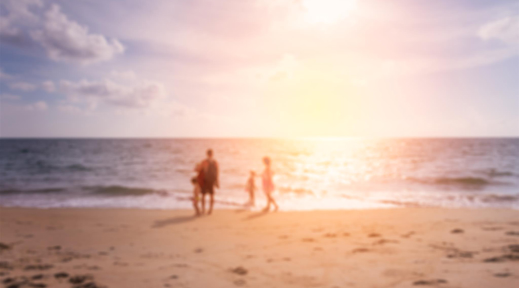 blured of happy family playing at the beach