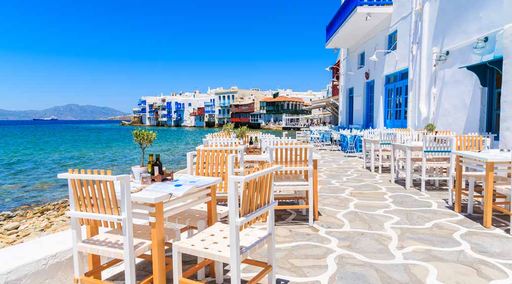 Chairs with tables in typical Greek tavern in Little Venice part of Mykonos town Mykonos island Greece