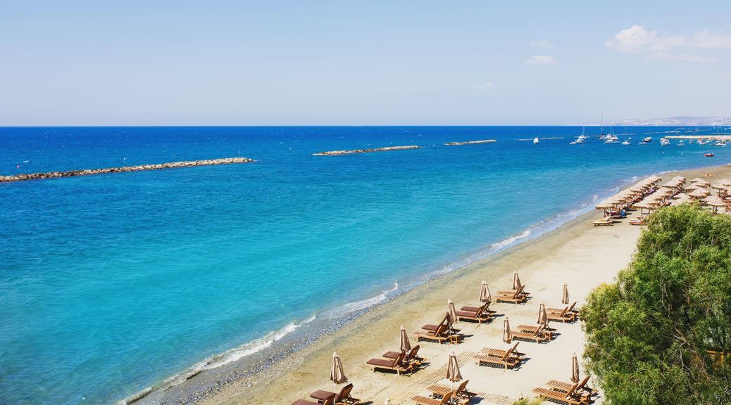 Limassol beach chairs and umbrellas on sand beach