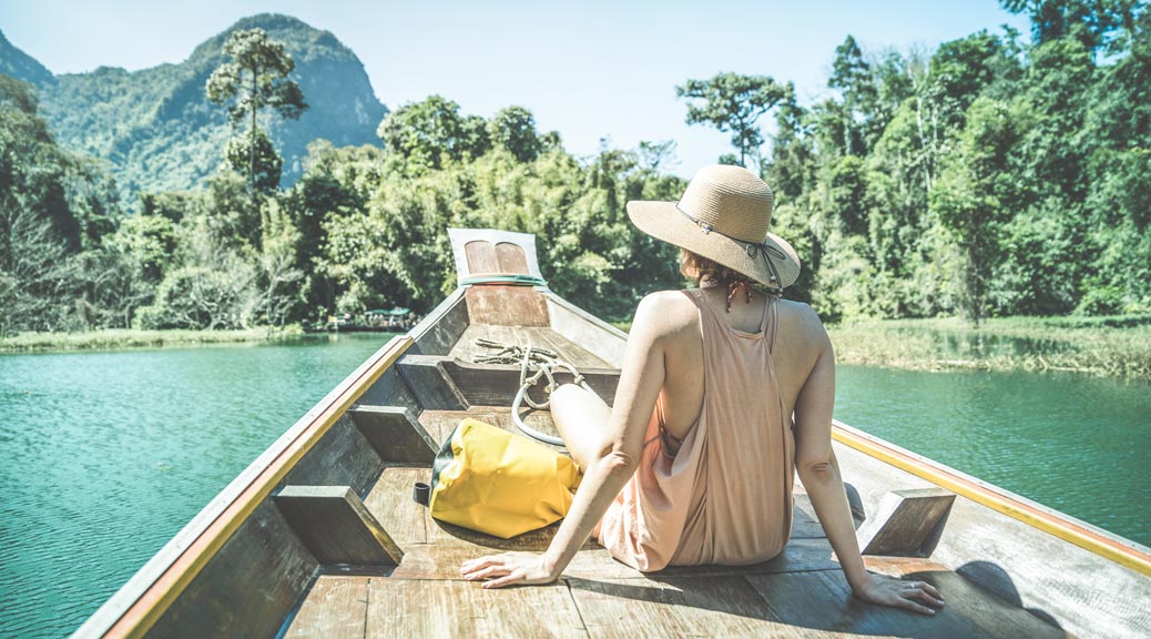 Young woman traveler on longtail boat trip at island hopping